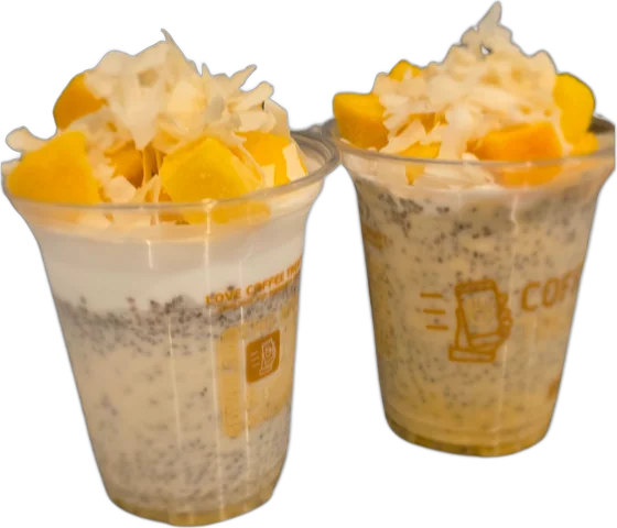Chia Puddings: two cups of chia pudding topped with mango pieces and coconut flakes